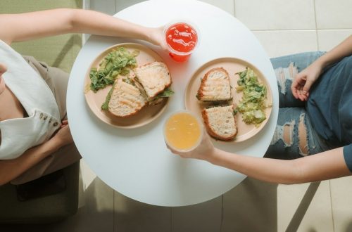 A woman sitting at a table with a plate of food