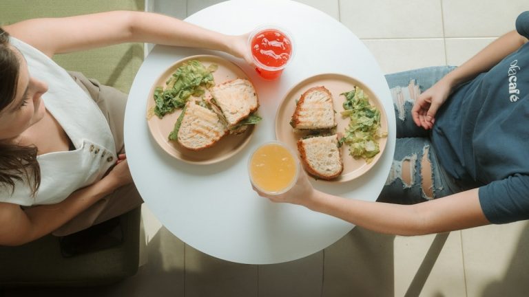 A woman sitting at a table with a plate of food